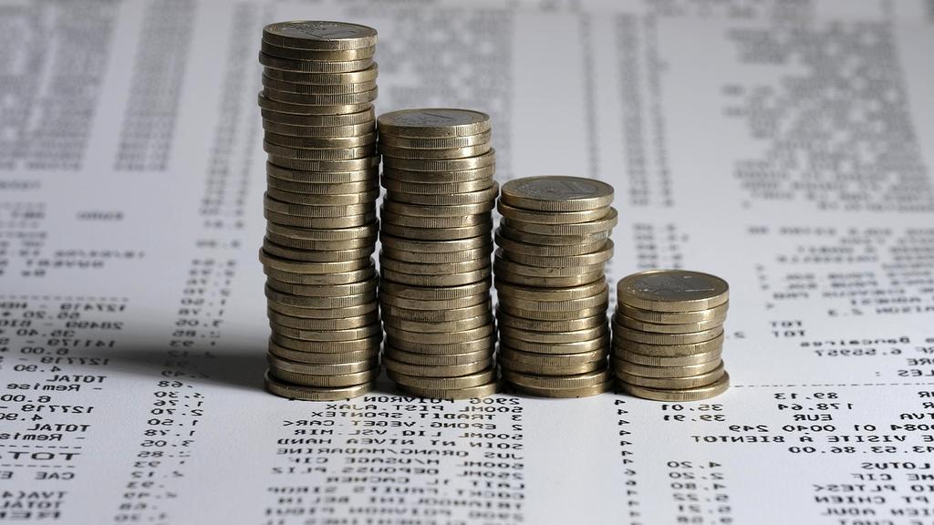 Person planning finances with calculator and notebook